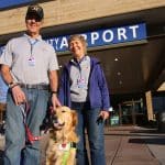 Dan and Kathie Brusseau with therapy dog Dillon outside of Rapid City Airport