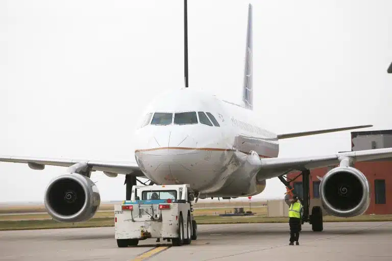 An airplane and ground handler on the pavement at Rapid City Regional Airport