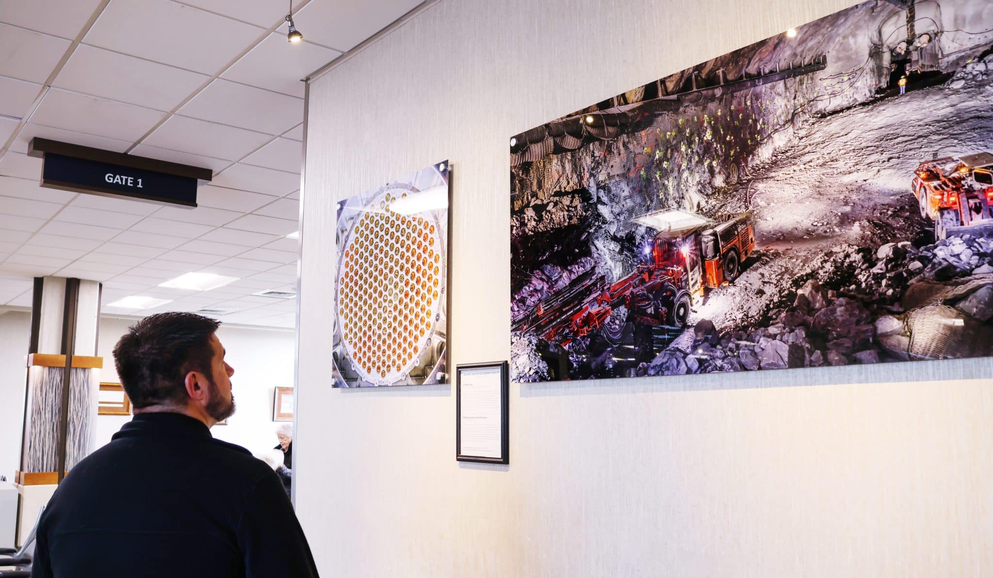 20240311_SURF_MJohnson ✈️ Rapid City Regional Airport A Rapid City Regional Airport passenger views part of the new exhibit, The Science at SURF: Images from the Underground, Lead, SD.