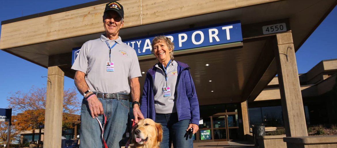 Dan and Kathie Brusseau with therapy dog Dillon outside of Rapid City Airport